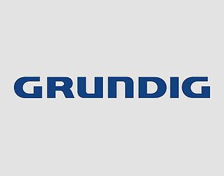Das Bild zeigt das Wort "GRUNDIG" in fettgedruckten Großbuchstaben, zentriert auf einem einfachen weißen Hintergrund, was auf ein Firmenlogo hindeutet.